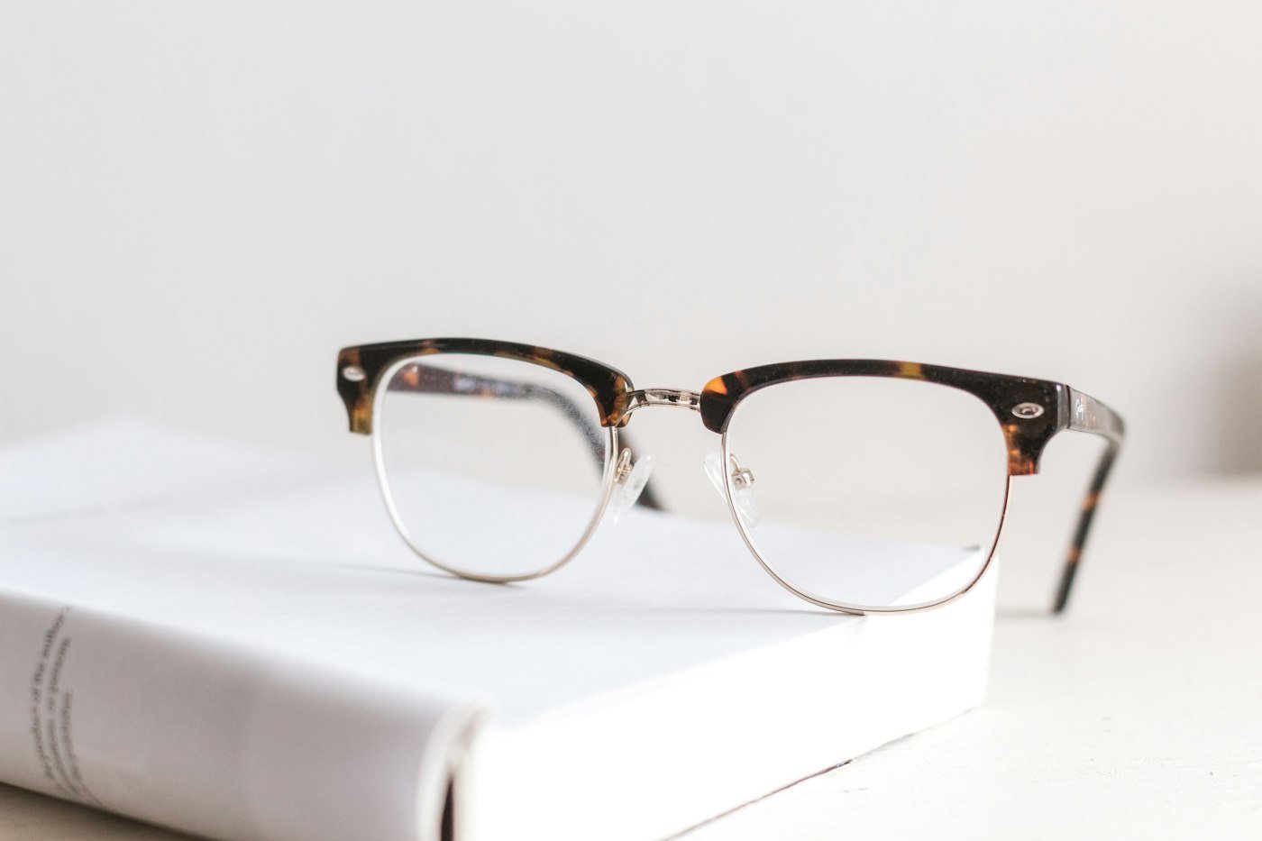 Stock photograph of eyeglasses on a book
